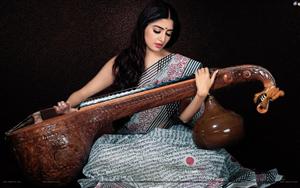 Poonam Kaur elegant avatar while playing a musical instrument